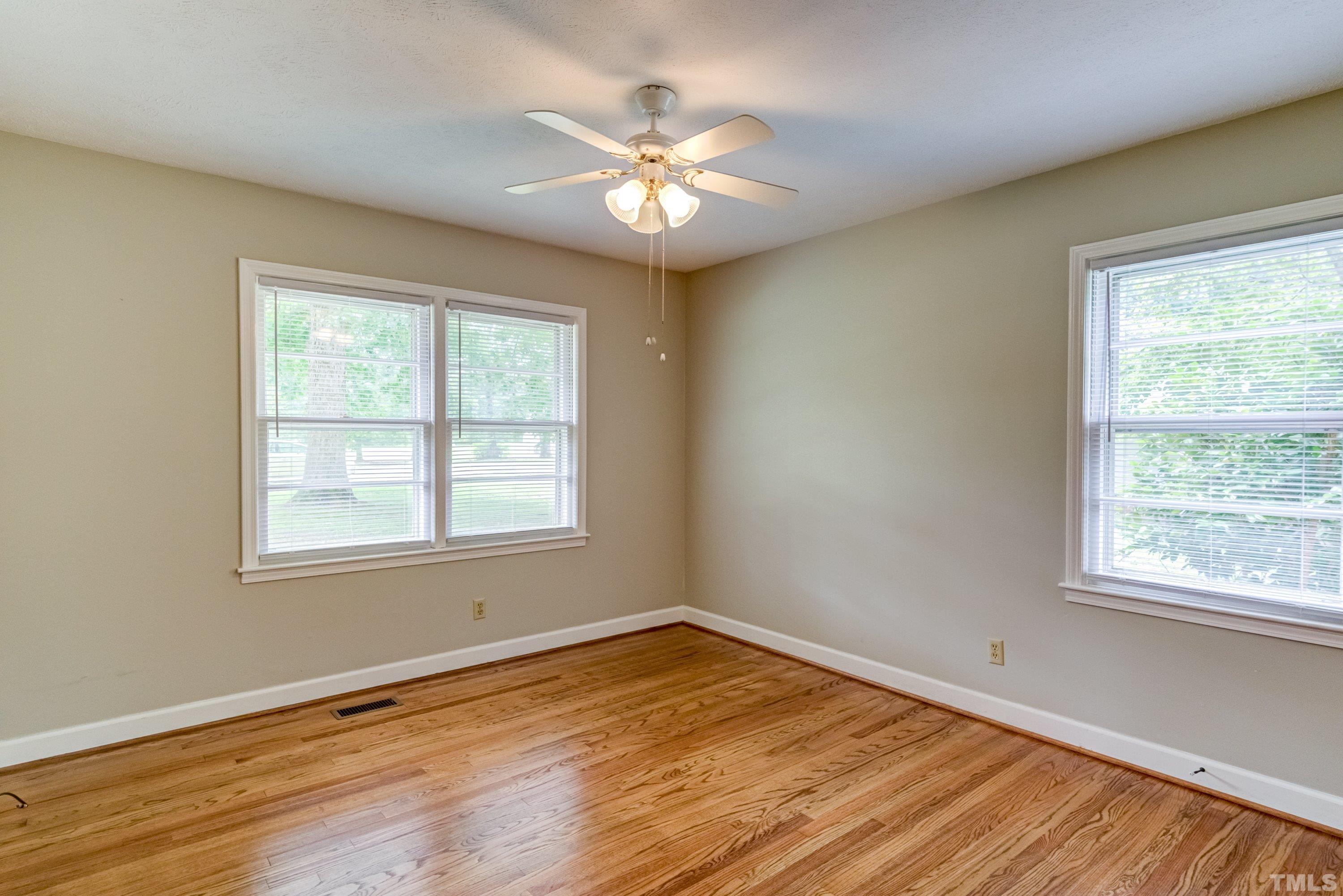 128 Spring Lane Lillington, NC 27546 - Photo 13 of 42 a view of an empty room with wooden floor and a window