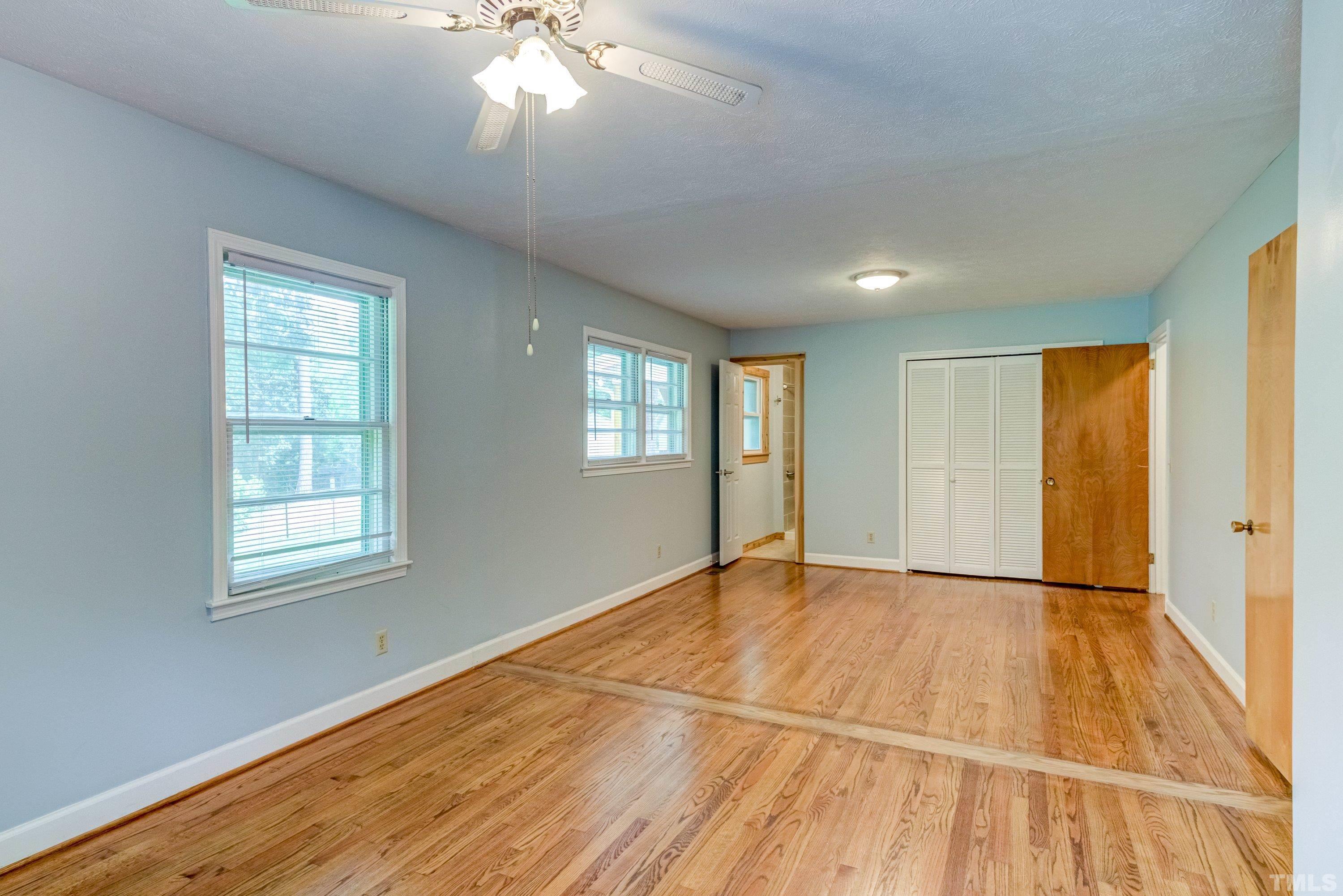 128 Spring Lane Lillington, NC 27546 - Photo 15 of 42 a view of an empty room with wooden floor and a window