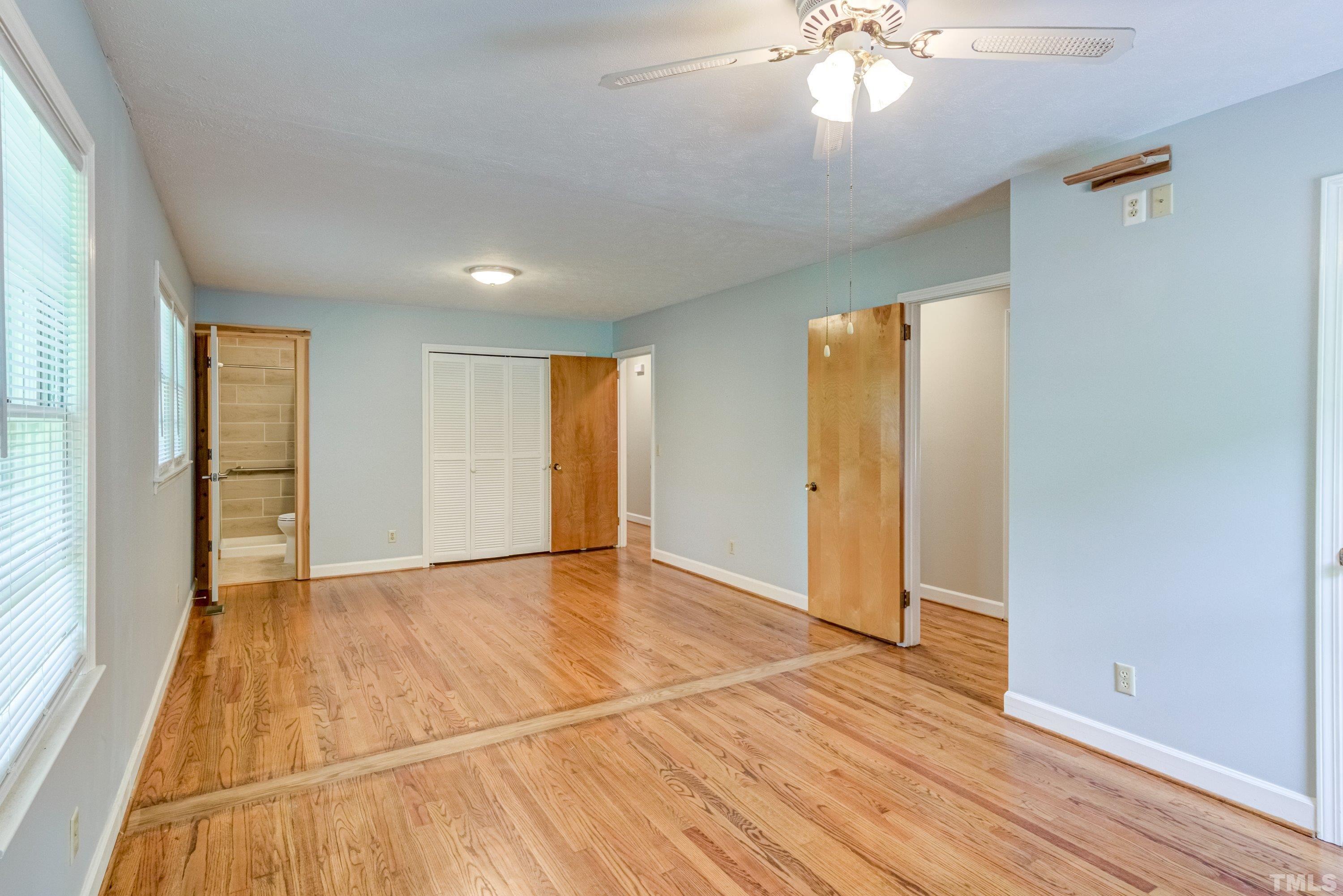 128 Spring Lane Lillington, NC 27546 - Photo 16 of 42 an empty room with wooden floor and windows