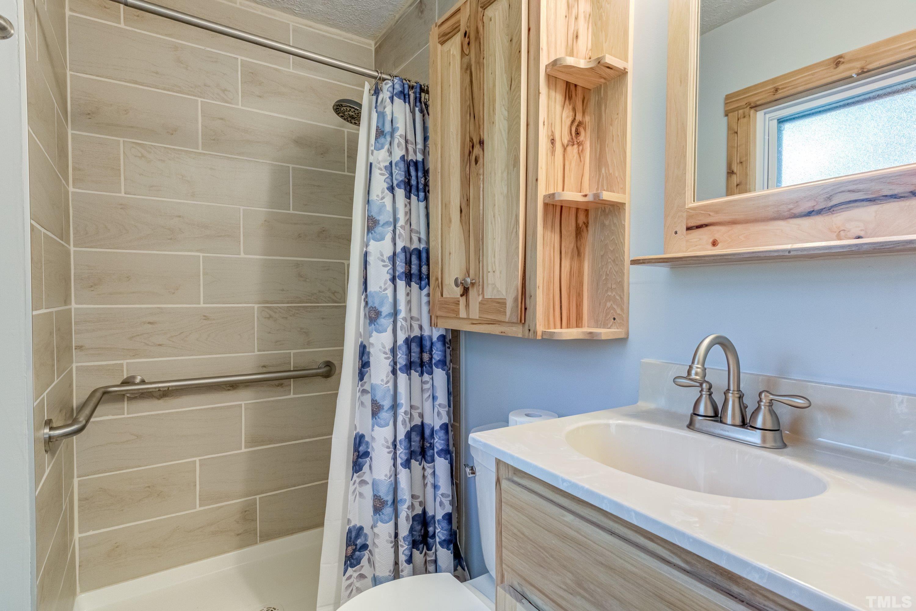 128 Spring Lane Lillington, NC 27546 - Photo 18 of 42 a bathroom with a sink and a shower