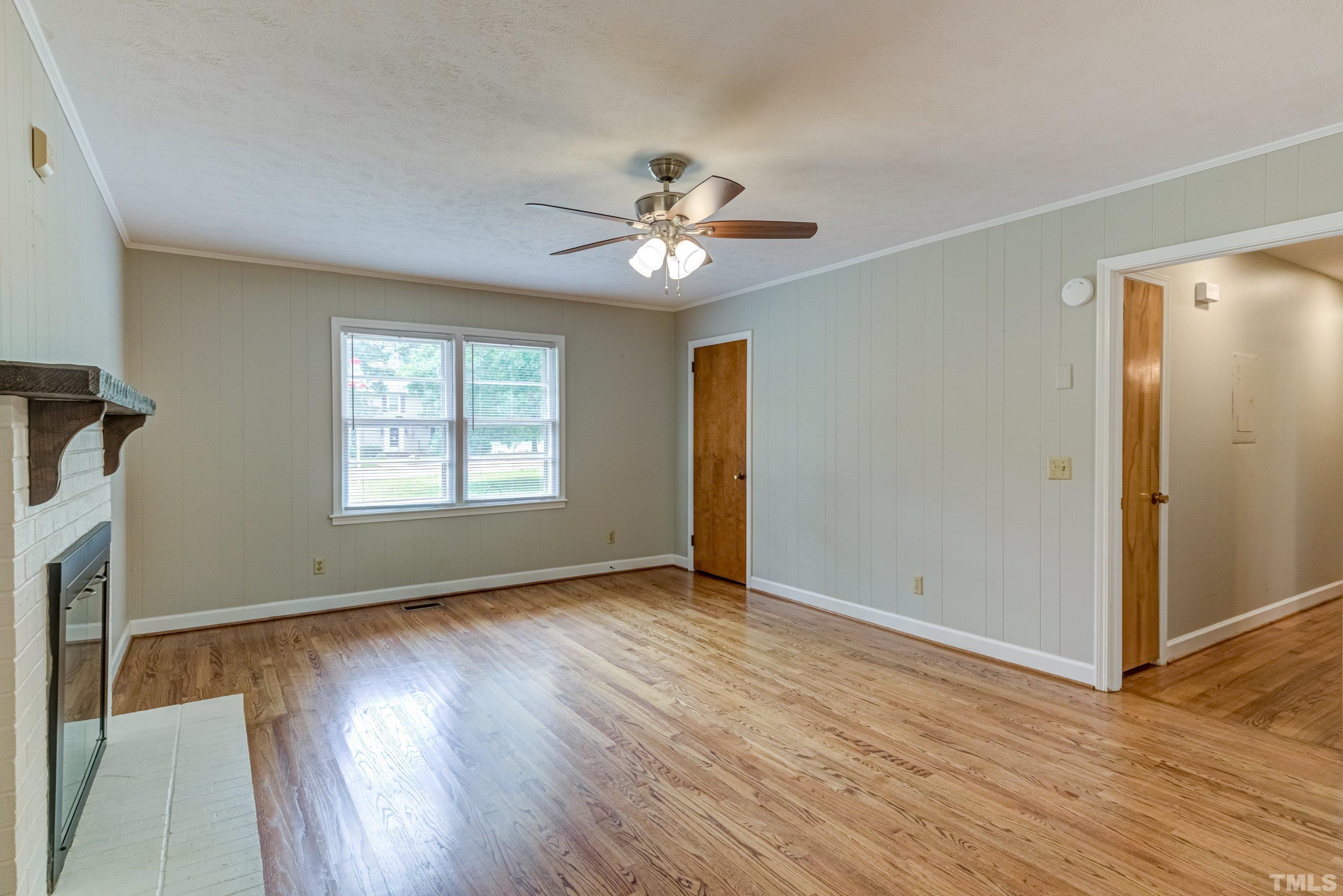 128 Spring Lane Lillington, NC 27546 - Photo 23 of 42 wooden floor in an empty room with a window