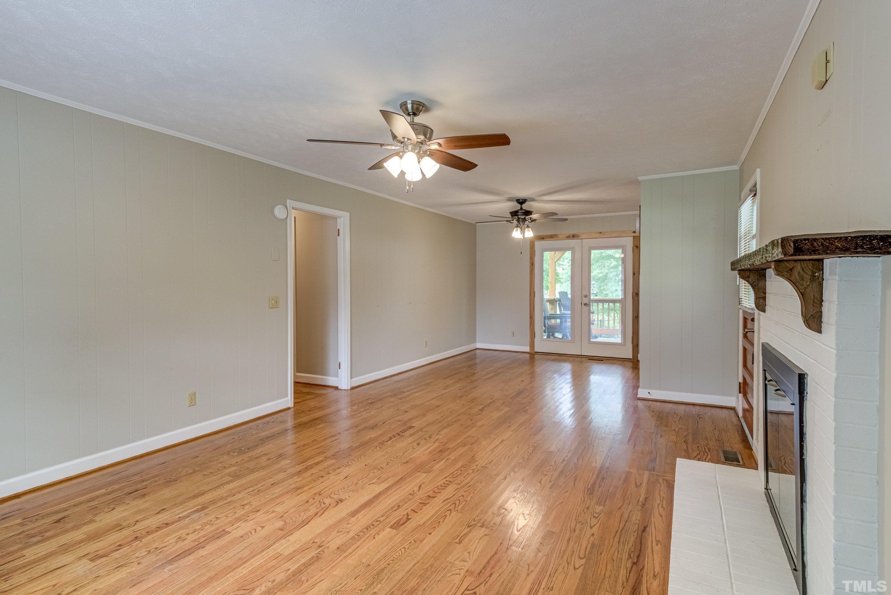128 Spring Lane Lillington, NC 27546 - Photo 24 of 42 a view of an empty room with window and wooden floor