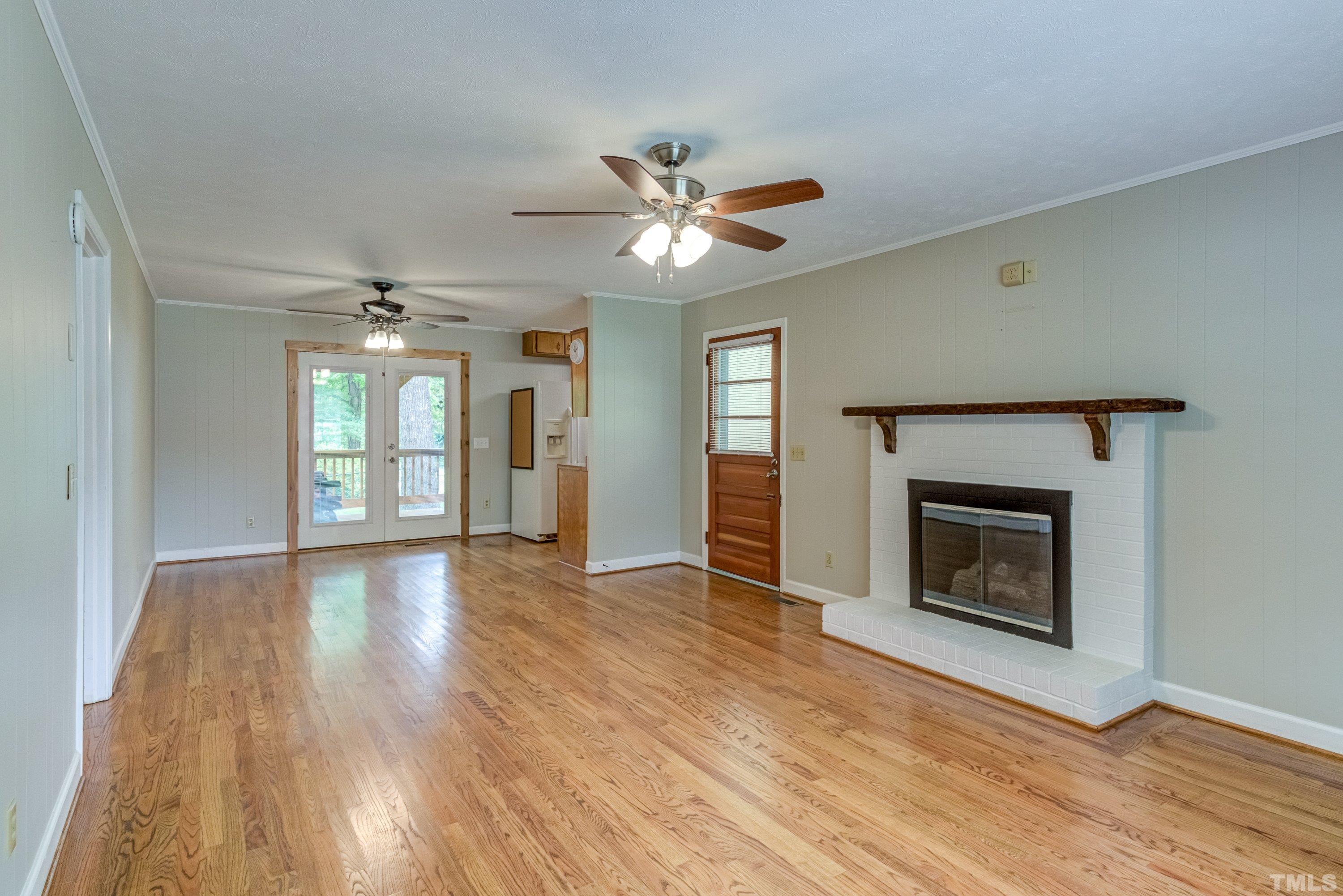 128 Spring Lane Lillington, NC 27546 - Photo 25 of 42 a view of empty room with wooden floor and fireplace
