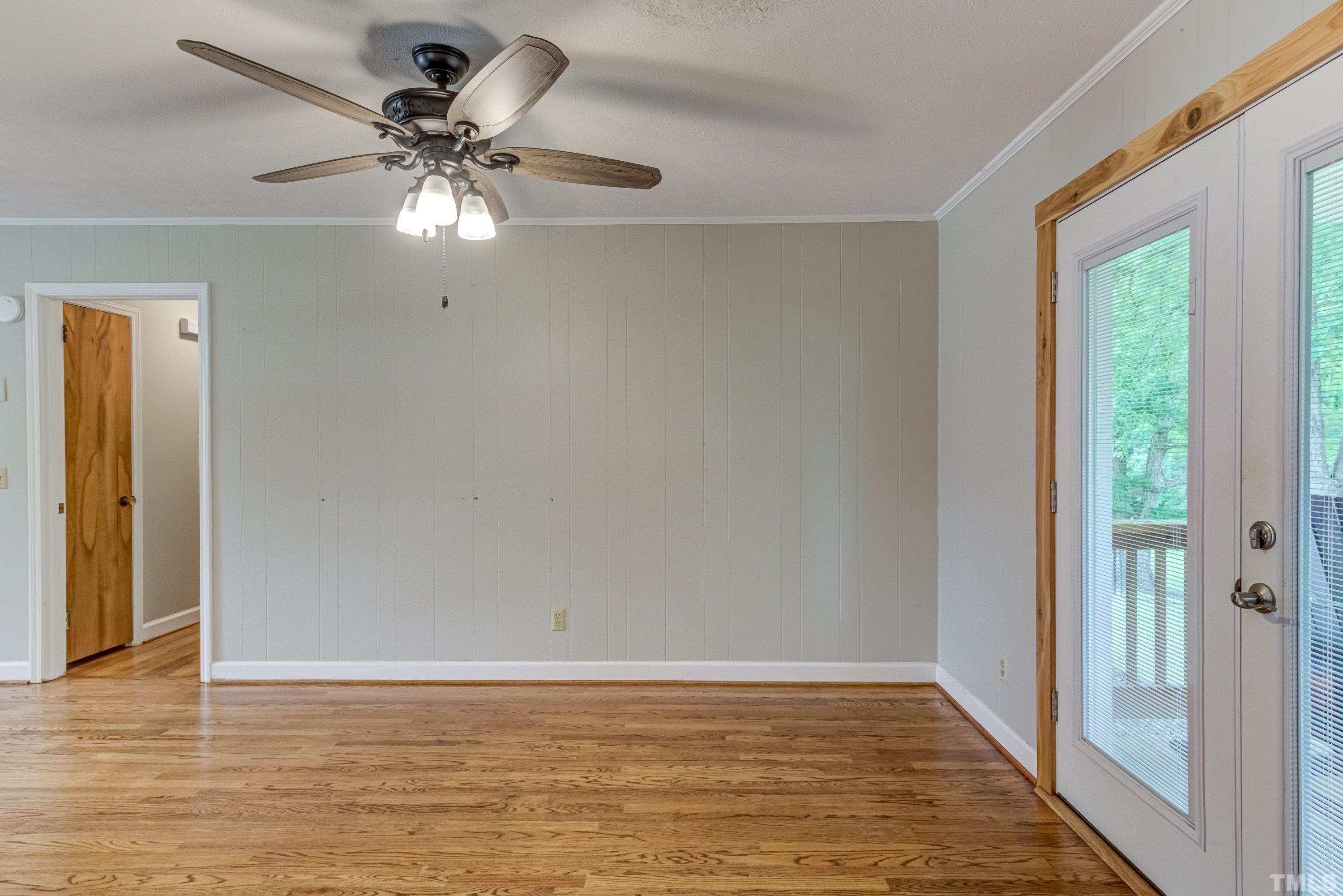 128 Spring Lane Lillington, NC 27546 - Photo 27 of 42 a view of an empty room with wooden floor and a window