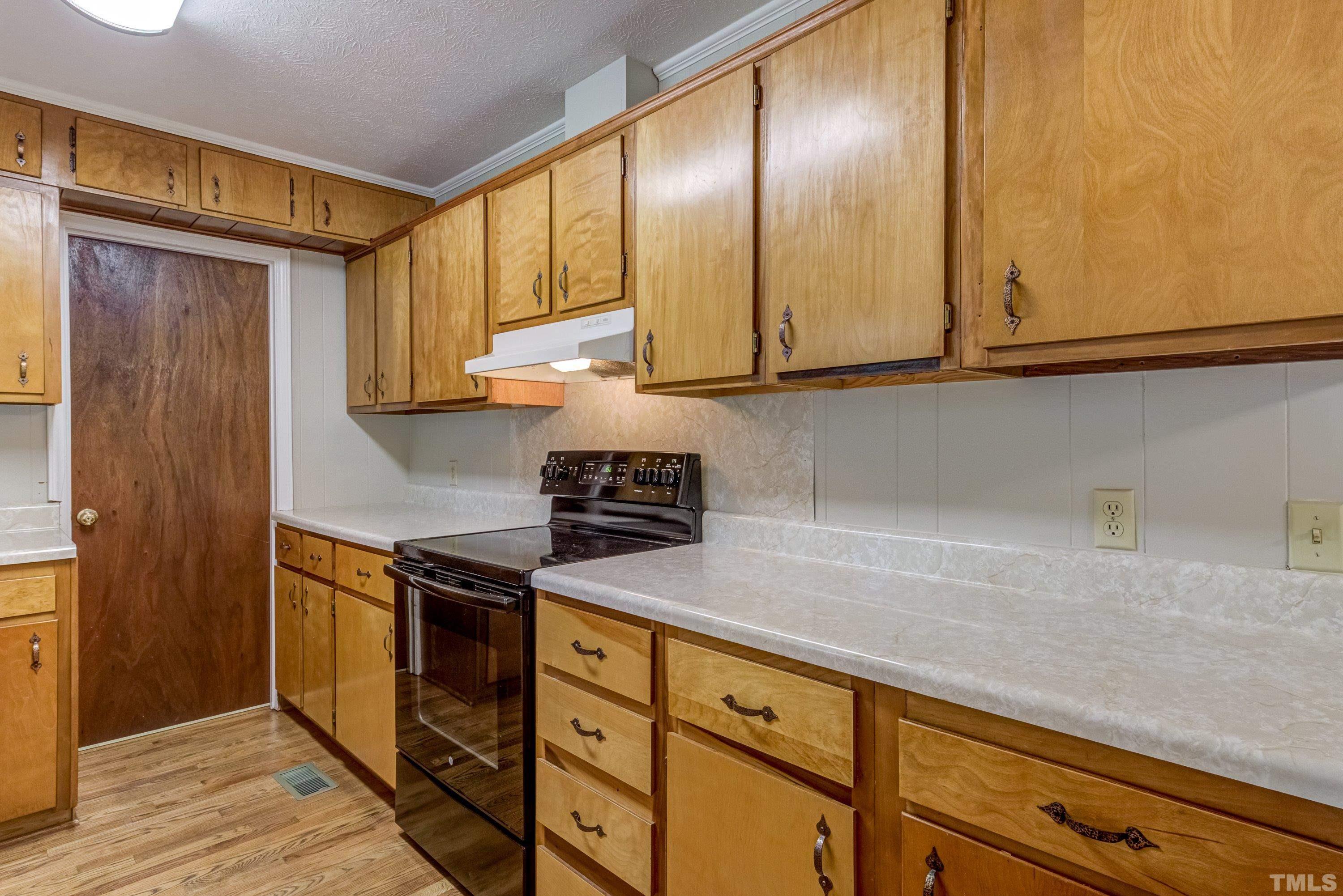 128 Spring Lane Lillington, NC 27546 - Photo 29 of 42 a kitchen with granite countertop cabinets stainless steel appliances and a counter space