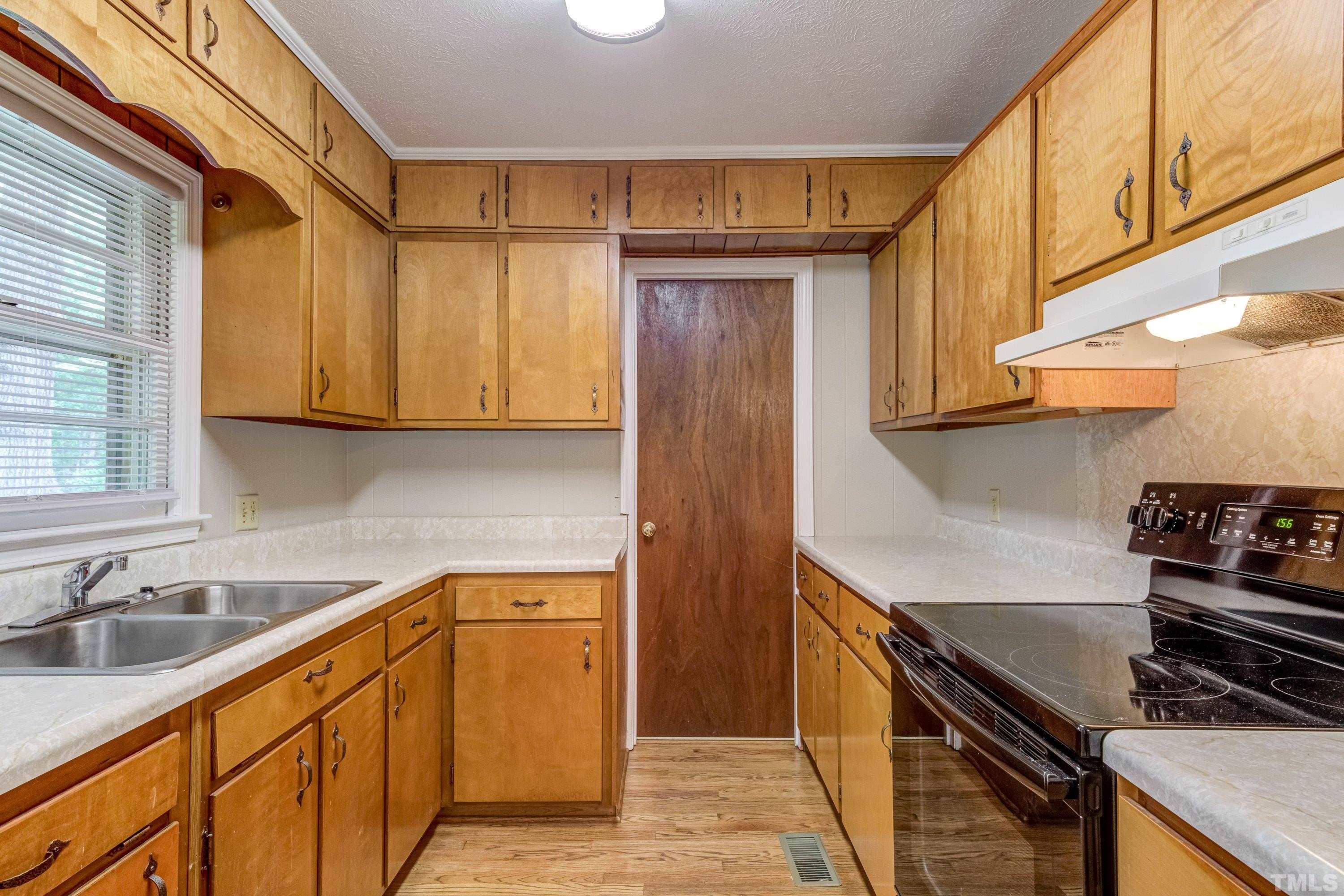 128 Spring Lane Lillington, NC 27546 - Photo 30 of 42 a kitchen with a sink stove and cabinets