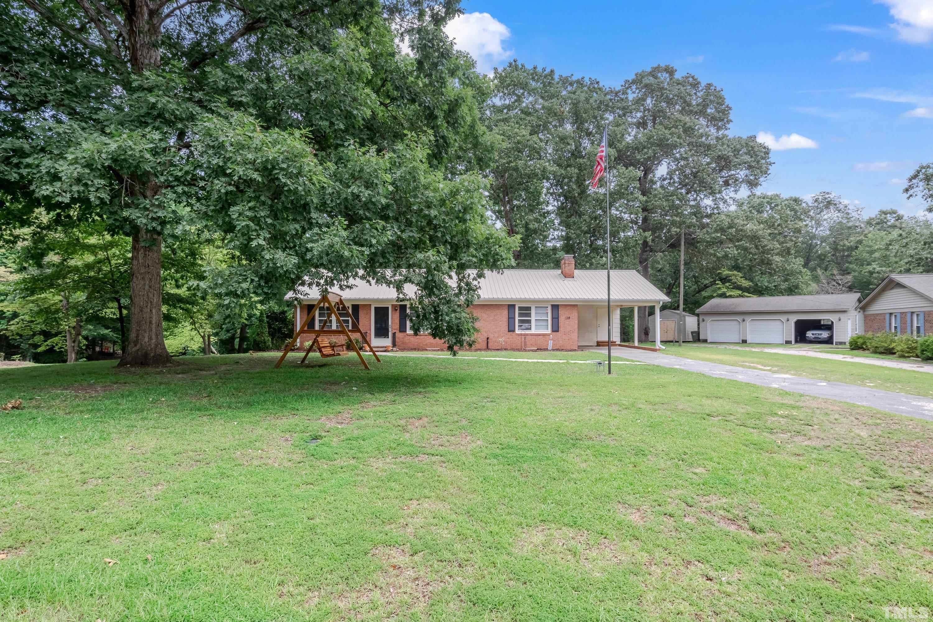 128 Spring Lane Lillington, NC 27546 - Photo 3 of 42 a view of a house with backyard and garden