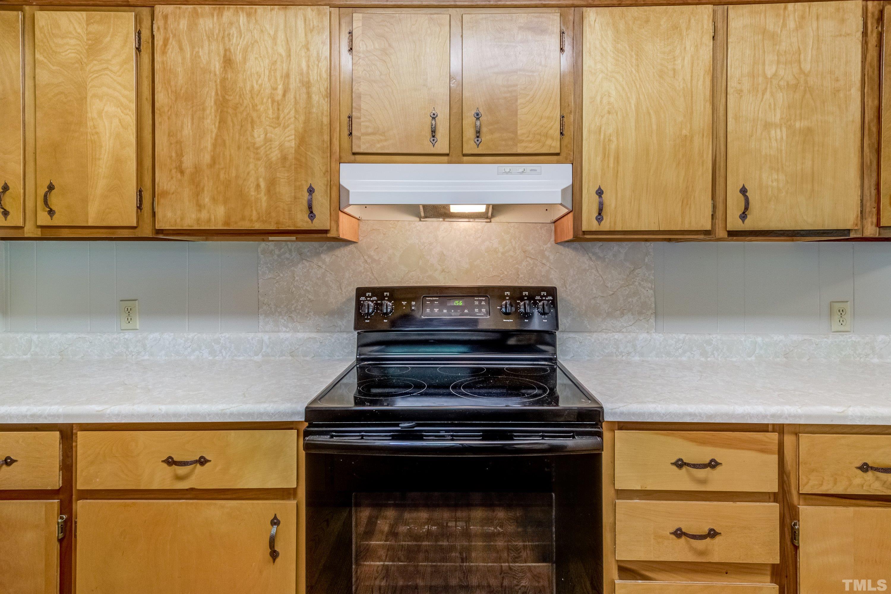 128 Spring Lane Lillington, NC 27546 - Photo 31 of 42 a stove top oven sitting inside of a kitchen