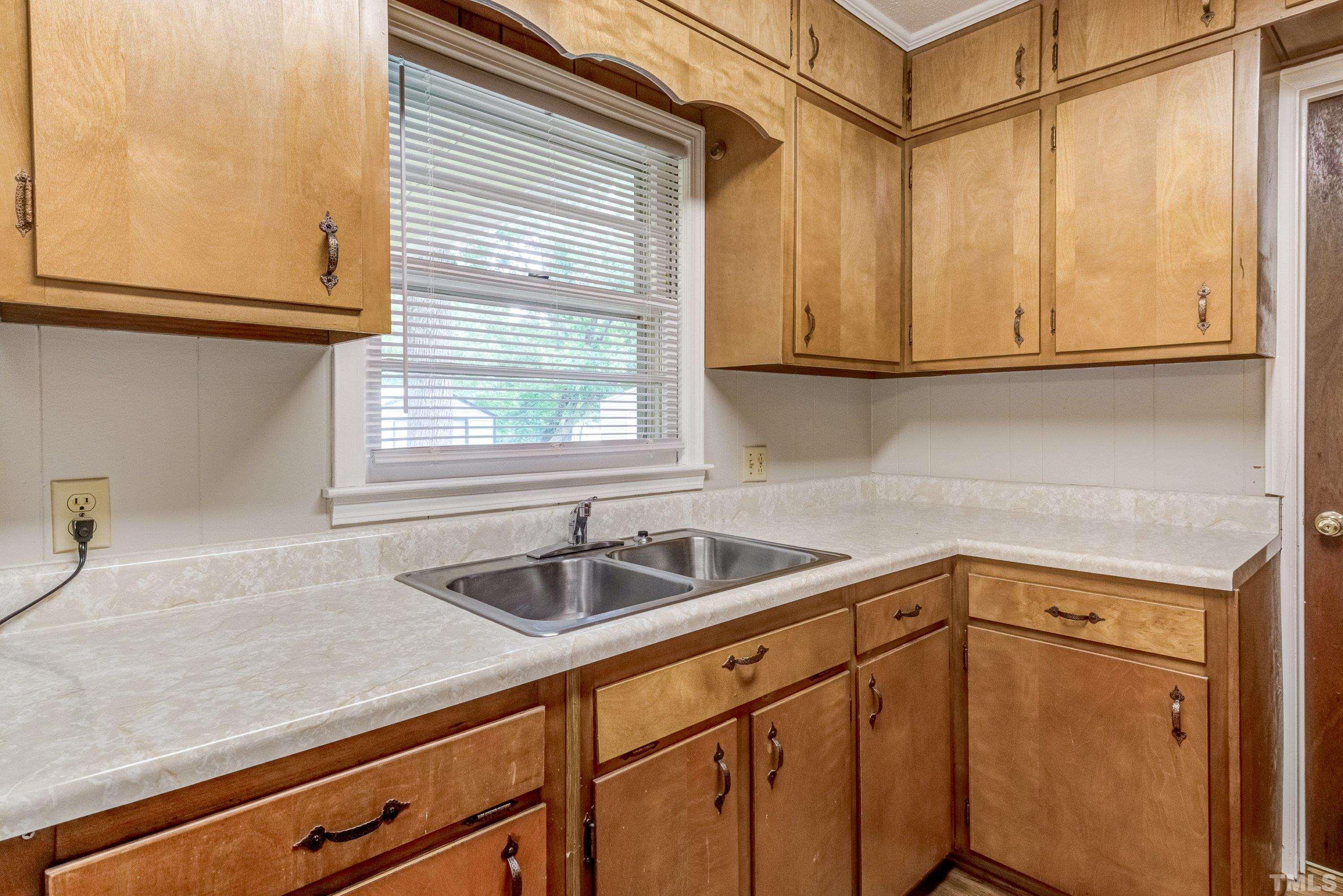 128 Spring Lane Lillington, NC 27546 - Photo 33 of 42 a kitchen with a sink and cabinets