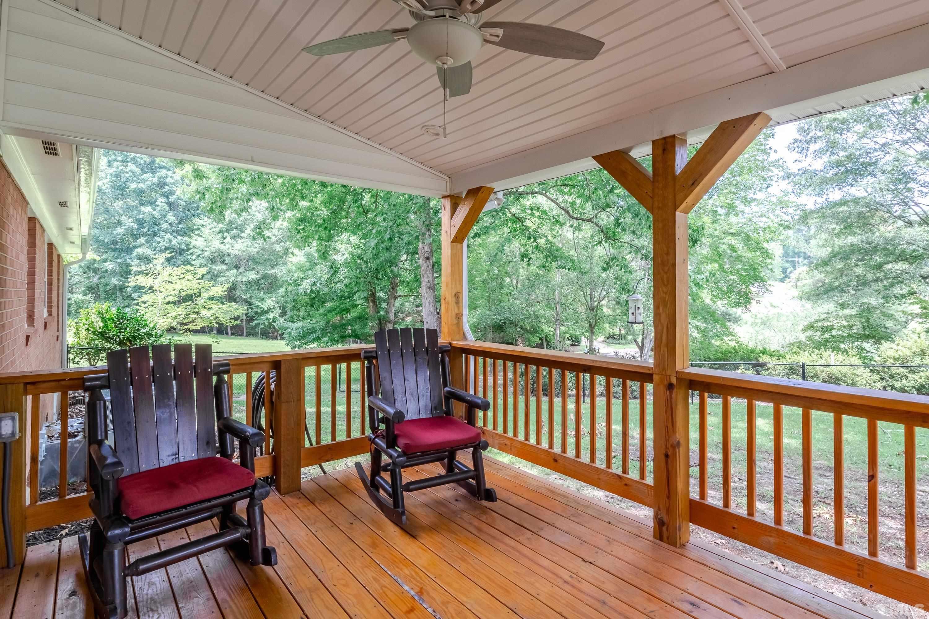 128 Spring Lane Lillington, NC 27546 - Photo 36 of 42 a balcony with chairs and wooden floor