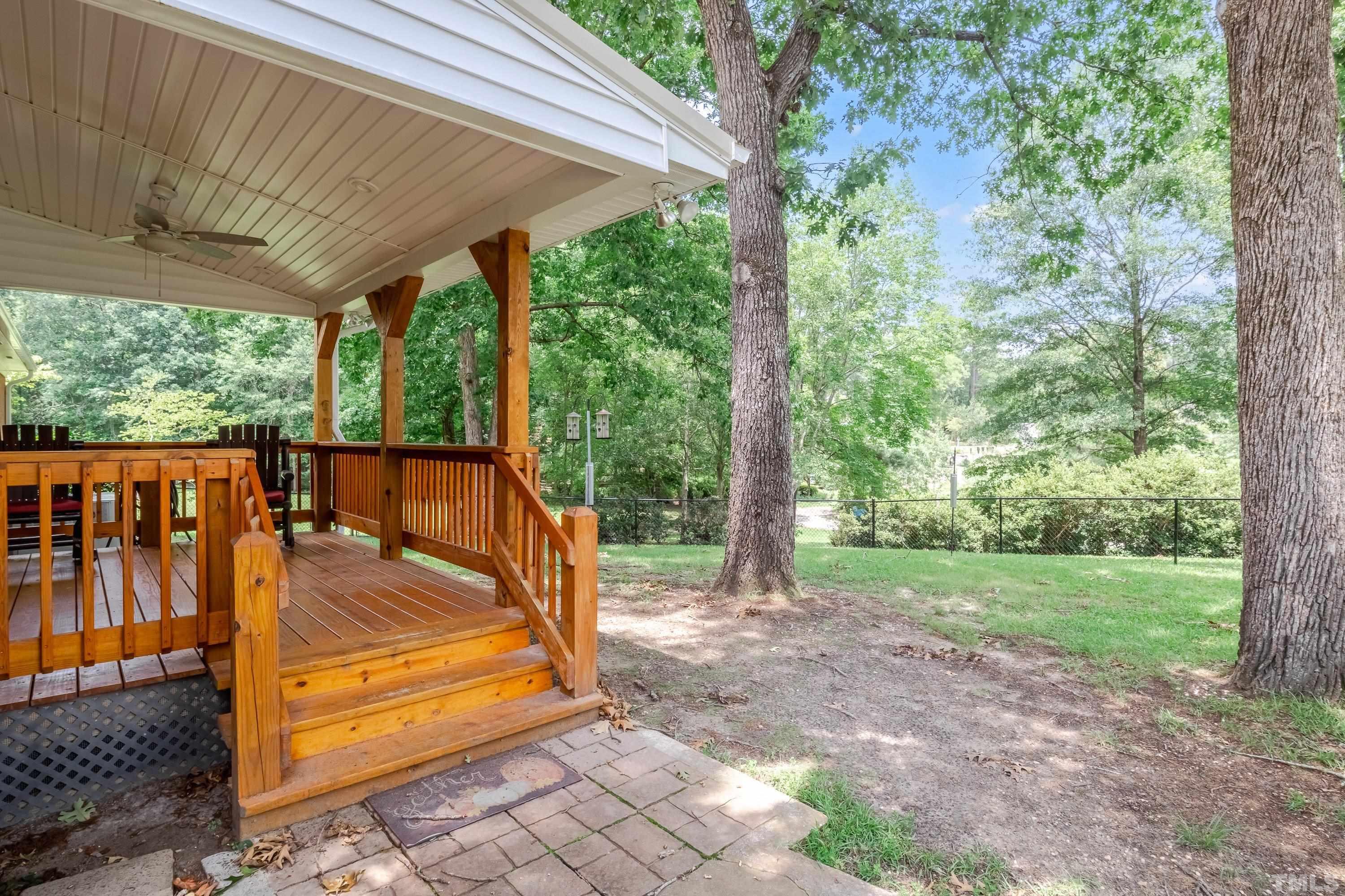 128 Spring Lane Lillington, NC 27546 - Photo 37 of 42 a view of a backyard with large trees and plants