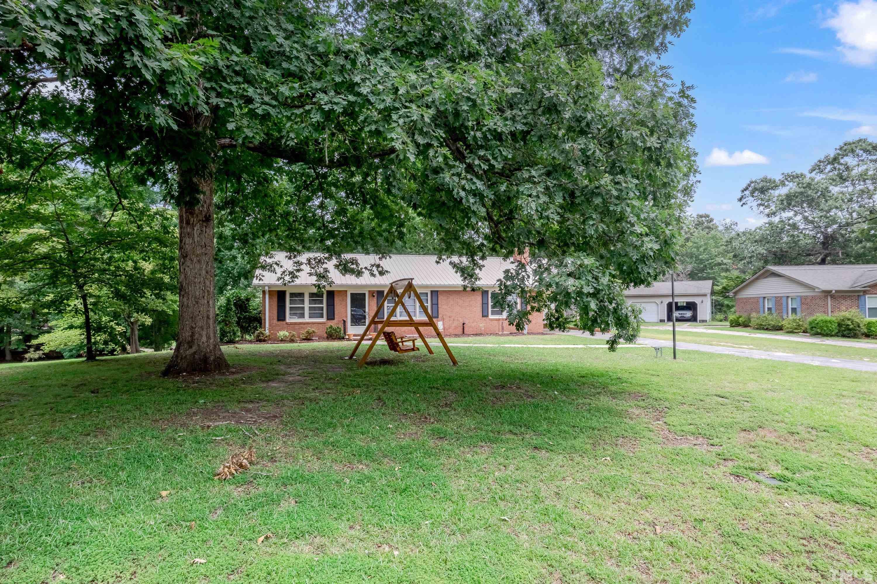 128 Spring Lane Lillington, NC 27546 - Photo 4 of 42 a view of a house with a backyard