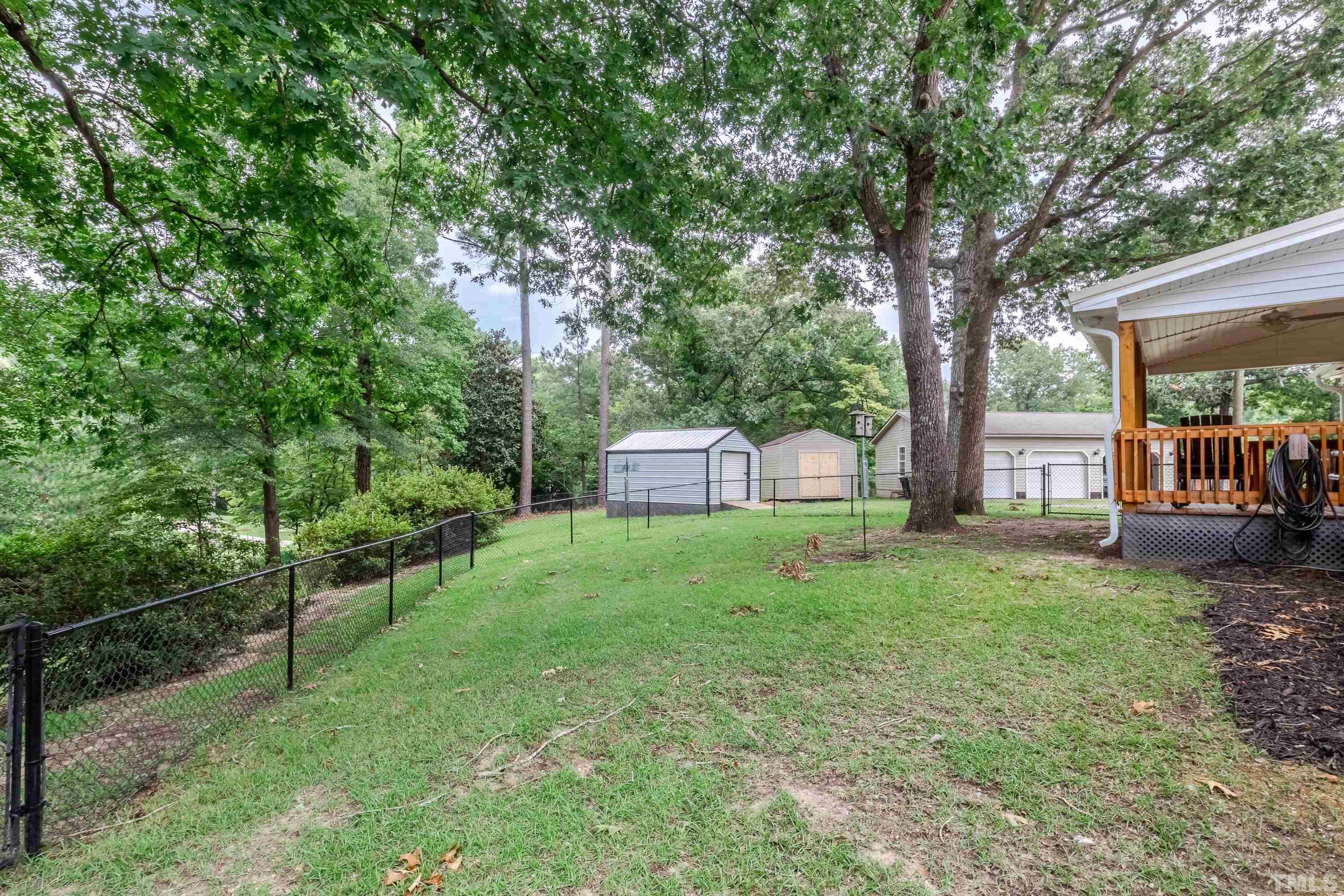 128 Spring Lane Lillington, NC 27546 - Photo 41 of 42 a view of a tree in front of a white house