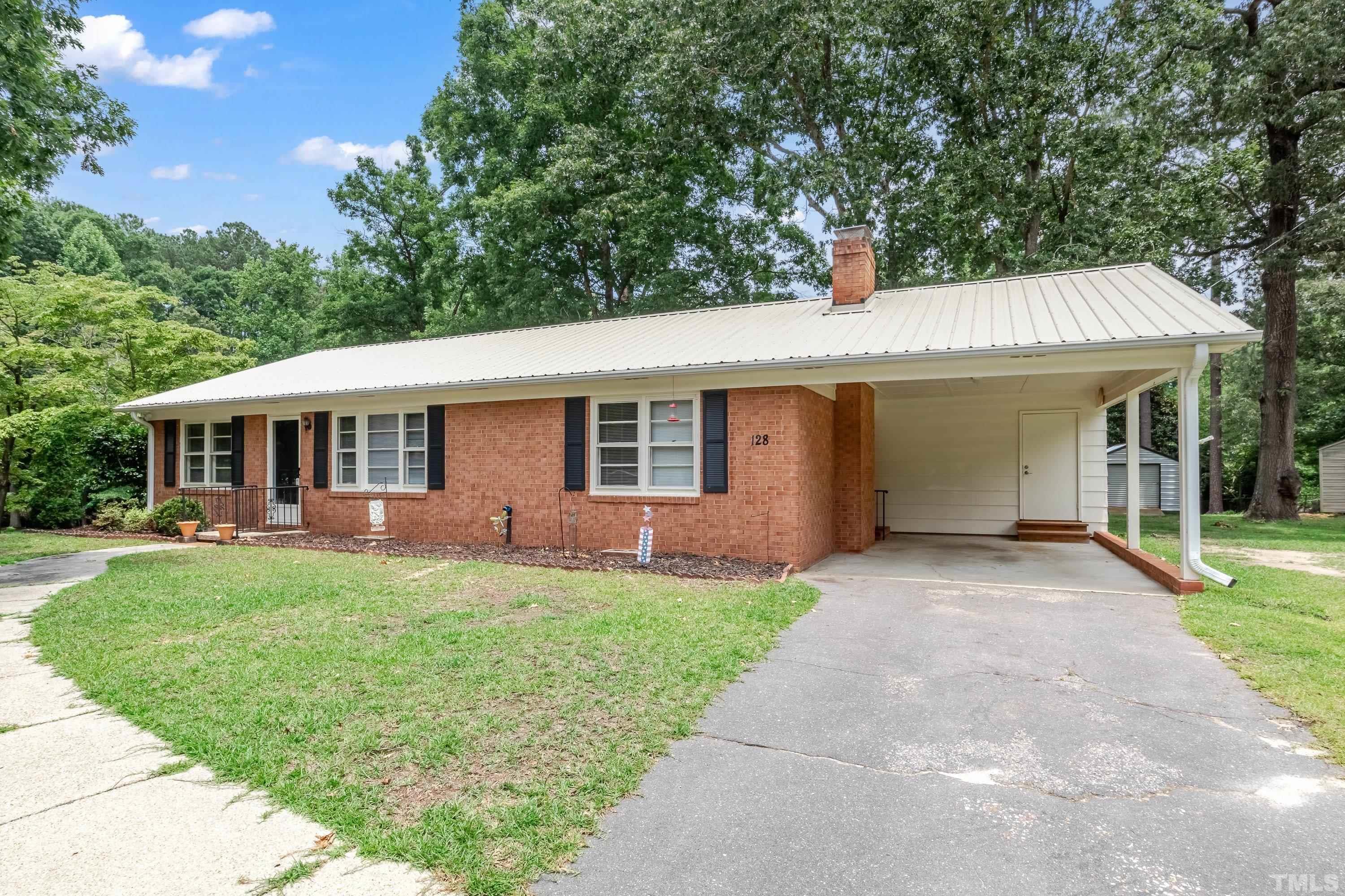 128 Spring Lane Lillington, NC 27546 - Photo 7 of 42 front view of a house and a yard