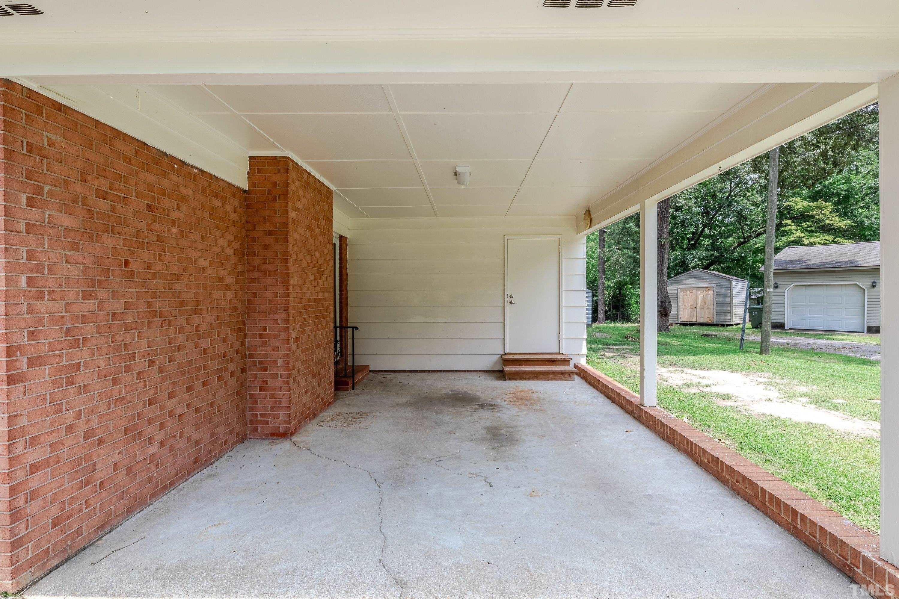 128 Spring Lane Lillington, NC 27546 - Photo 8 of 42 a view of a porch with a big yard and large tree