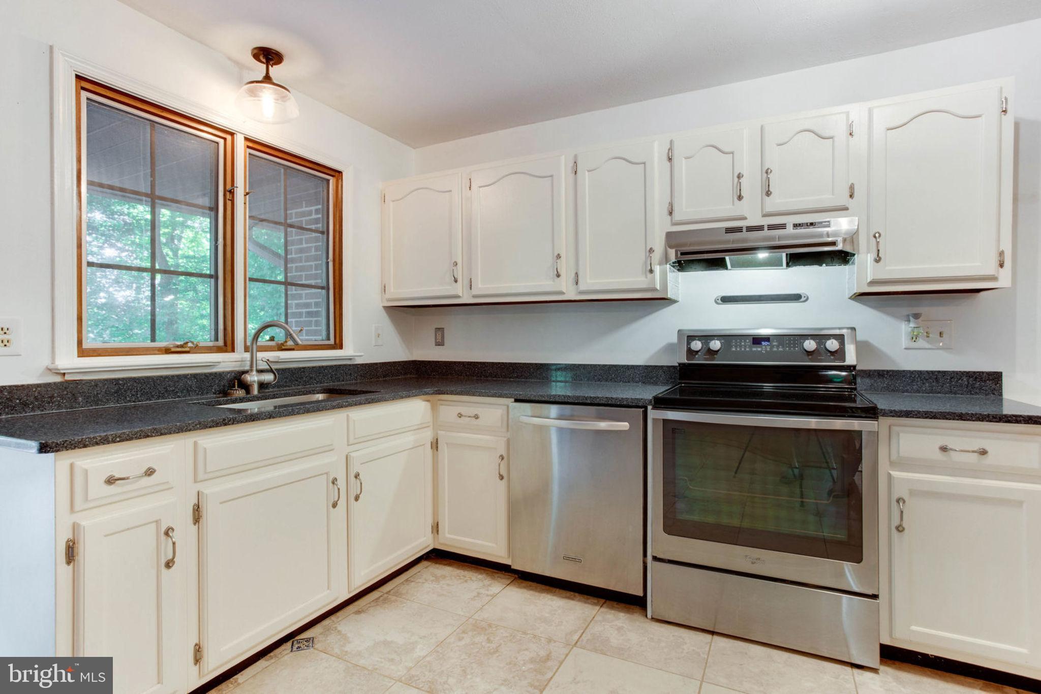 4304 Rousbys Run West River, MD 20778 - Photo 13 of 50 a kitchen with granite countertop white cabinets and white appliances