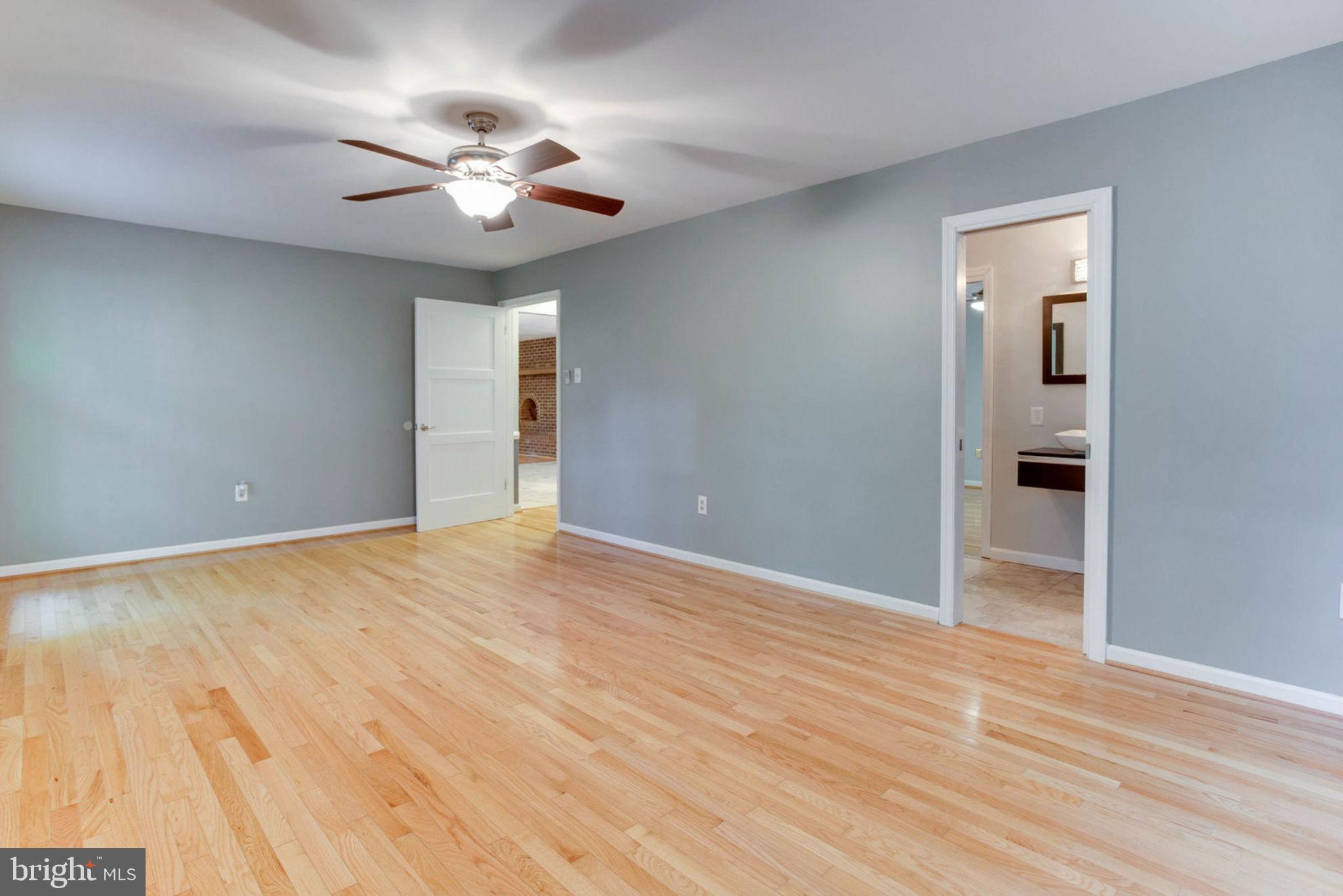 4304 Rousbys Run West River, MD 20778 - Photo 16 of 50 a view of an empty room with wooden floor and a ceiling fan