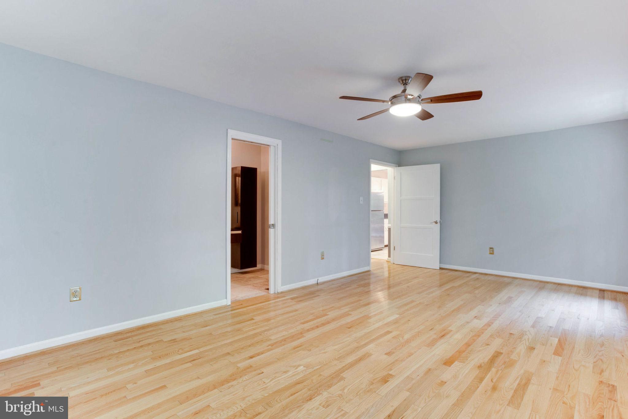 4304 Rousbys Run West River, MD 20778 - Photo 21 of 50 a view of empty room with wooden floor and fan