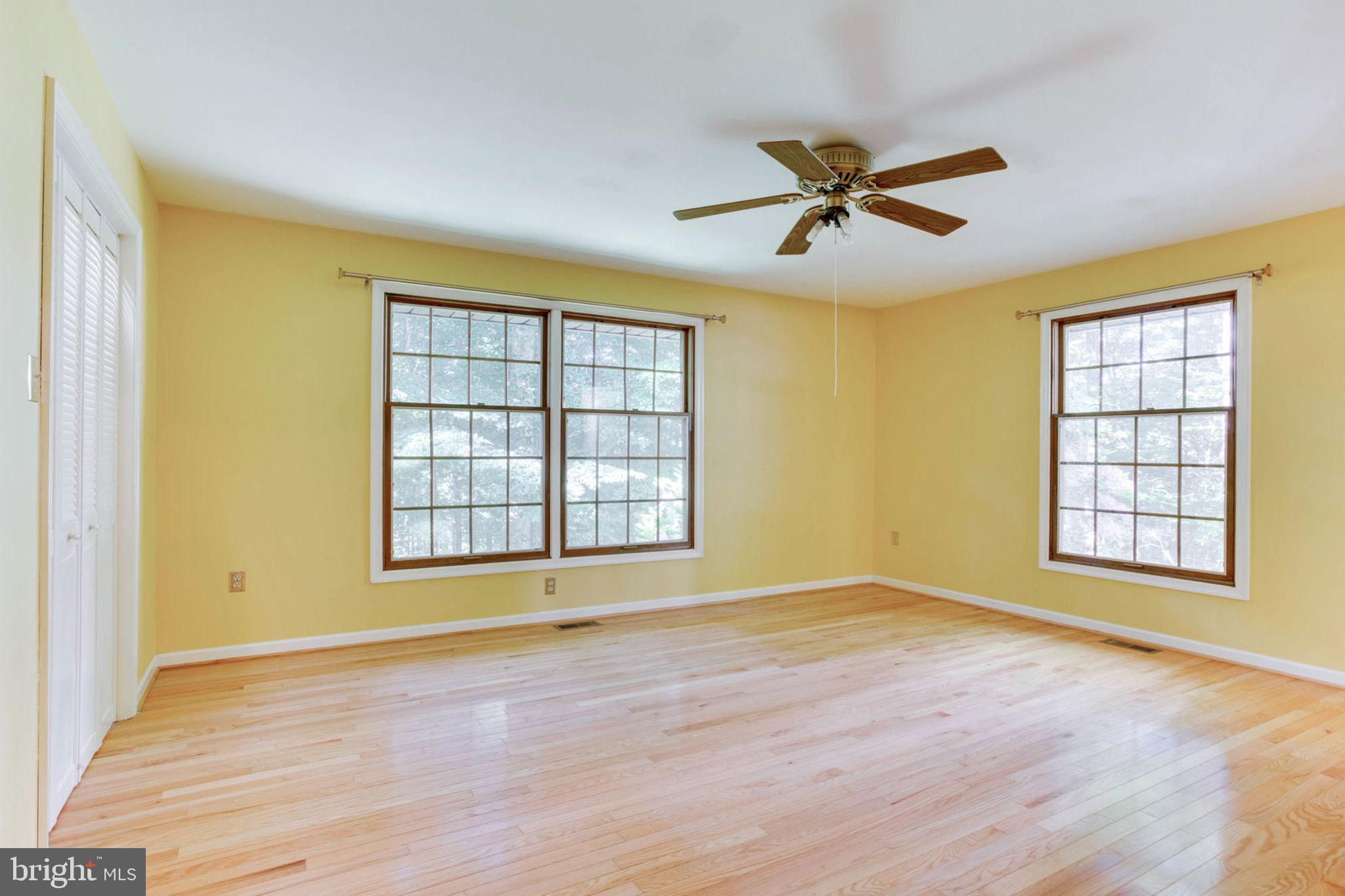 4304 Rousbys Run West River, MD 20778 - Photo 25 of 50 an empty room with wooden floor and windows
