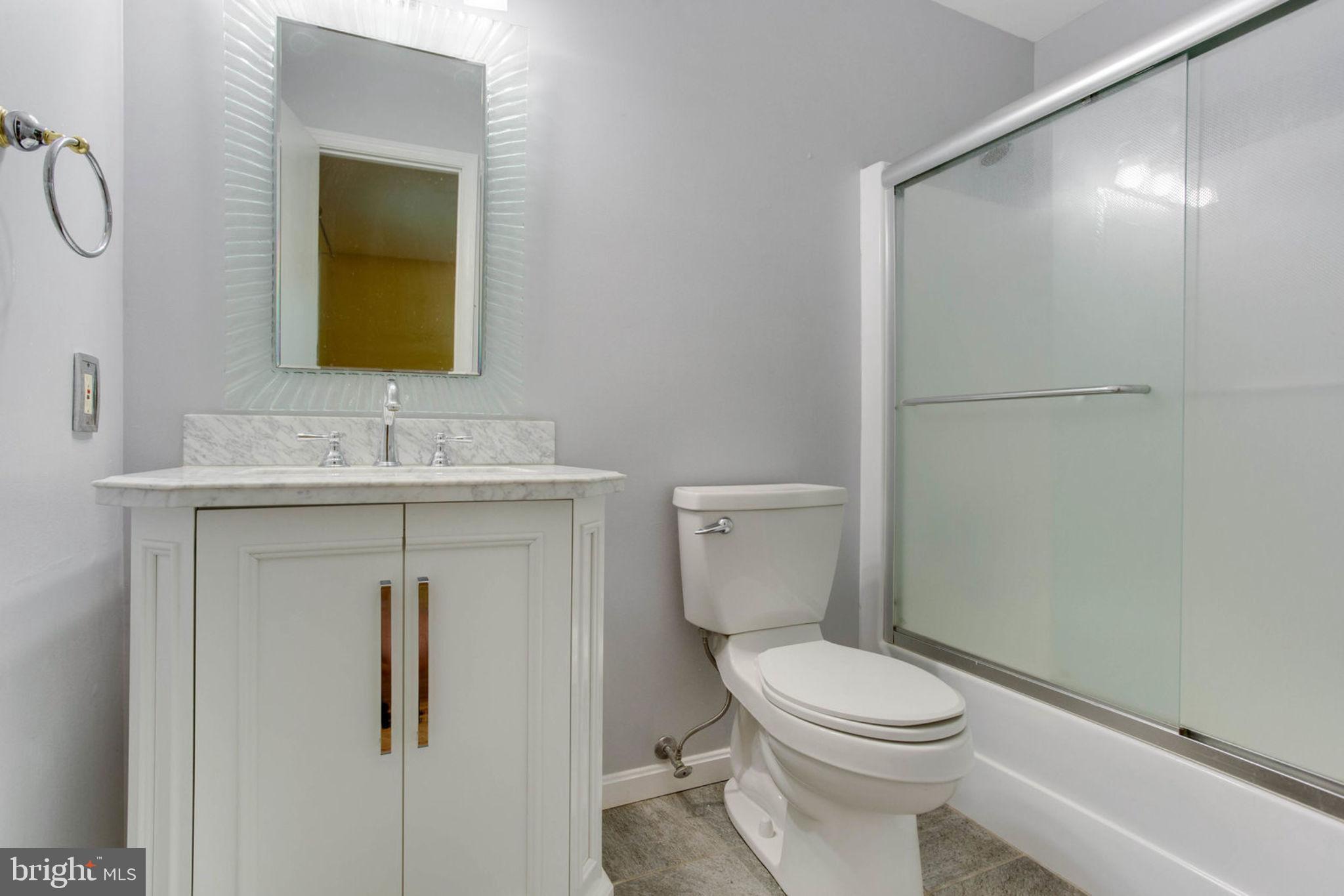 4304 Rousbys Run West River, MD 20778 - Photo 26 of 50 a bathroom with a toilet sink vanity and mirror