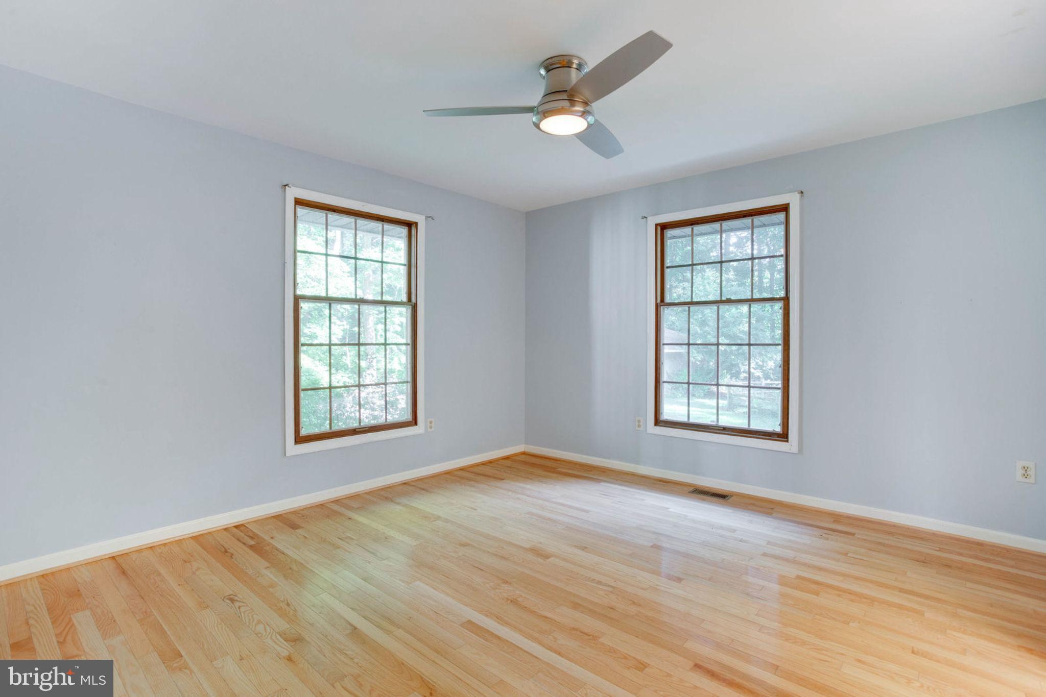 4304 Rousbys Run West River, MD 20778 - Photo 27 of 50 a view of an empty room with a window and wooden floor