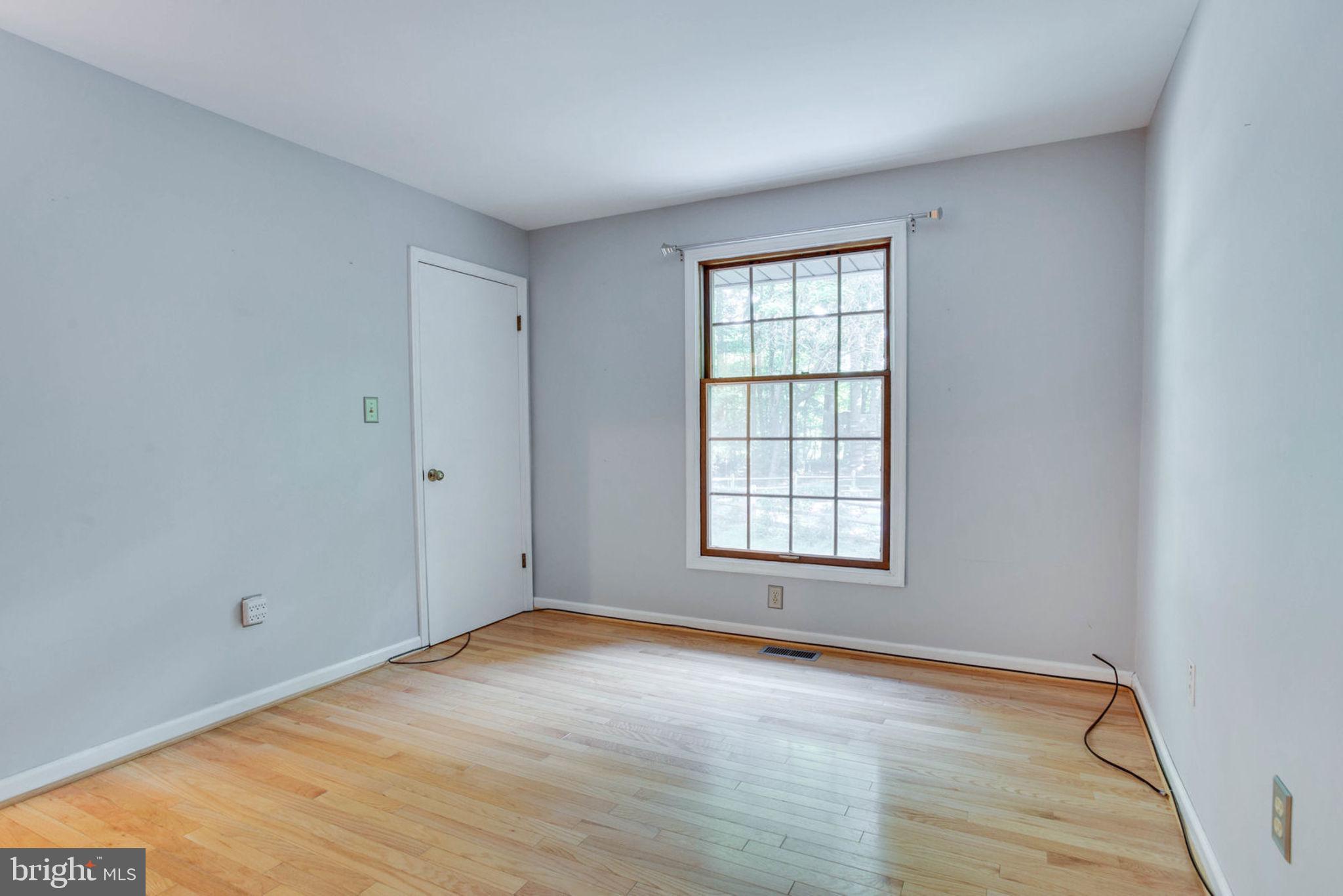 4304 Rousbys Run West River, MD 20778 - Photo 28 of 50 an empty room with wooden floor and windows