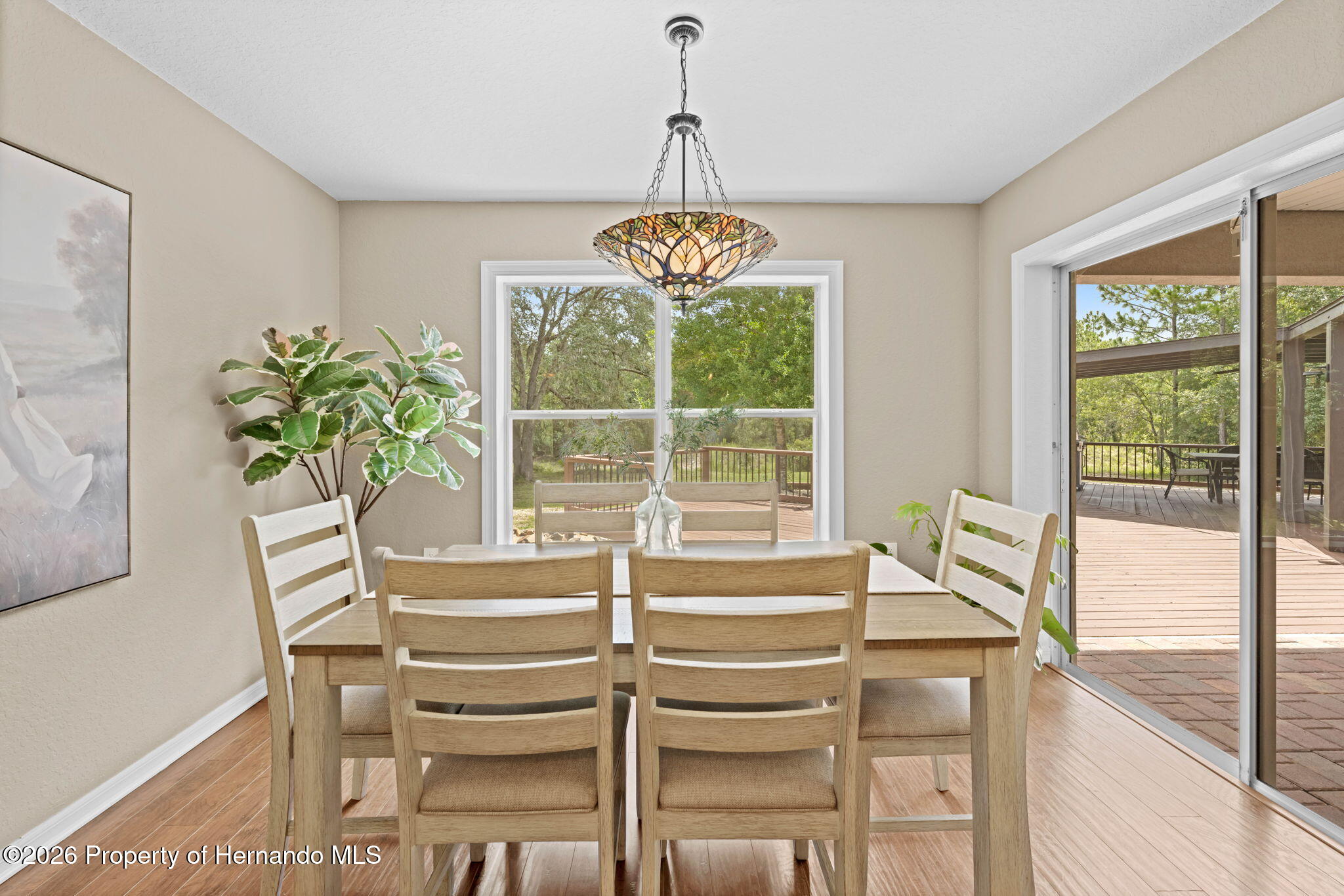 14220 Ermine Owl Road Brooksville, FL 34614 - Photo 15 of 54 a dining room with furniture and a window