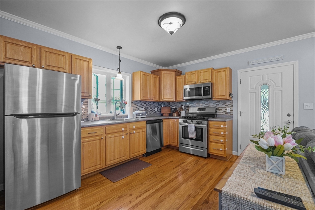 249 Baird Street Fall River, MA 02721 - Photo 4 of 23 a kitchen with stainless steel appliances granite countertop a refrigerator a stove microwave and sink