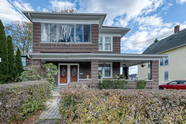 a front view of a house with garden
