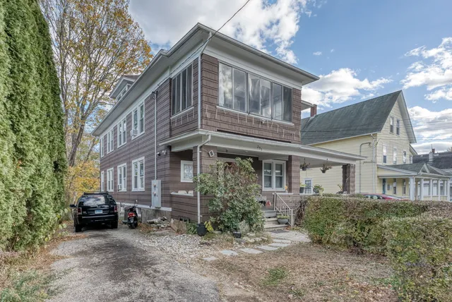 a view of a house with a yard and balcony
