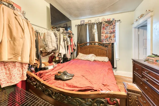 a bedroom with a bed and a dresser