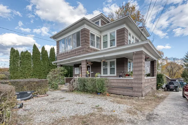 a front view of a house with a garden