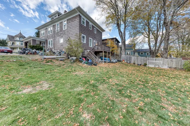 a view of a yard with a house and a tree