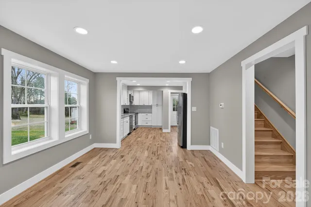 a view of entryway with wooden floor and stairs