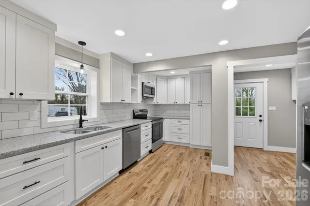 a kitchen with a sink window and cabinets