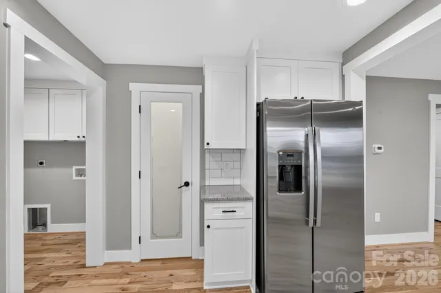 a kitchen with stainless steel appliances kitchen island a refrigerator and cabinets