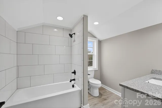 a bathroom with a bathtub a toilet and a shower