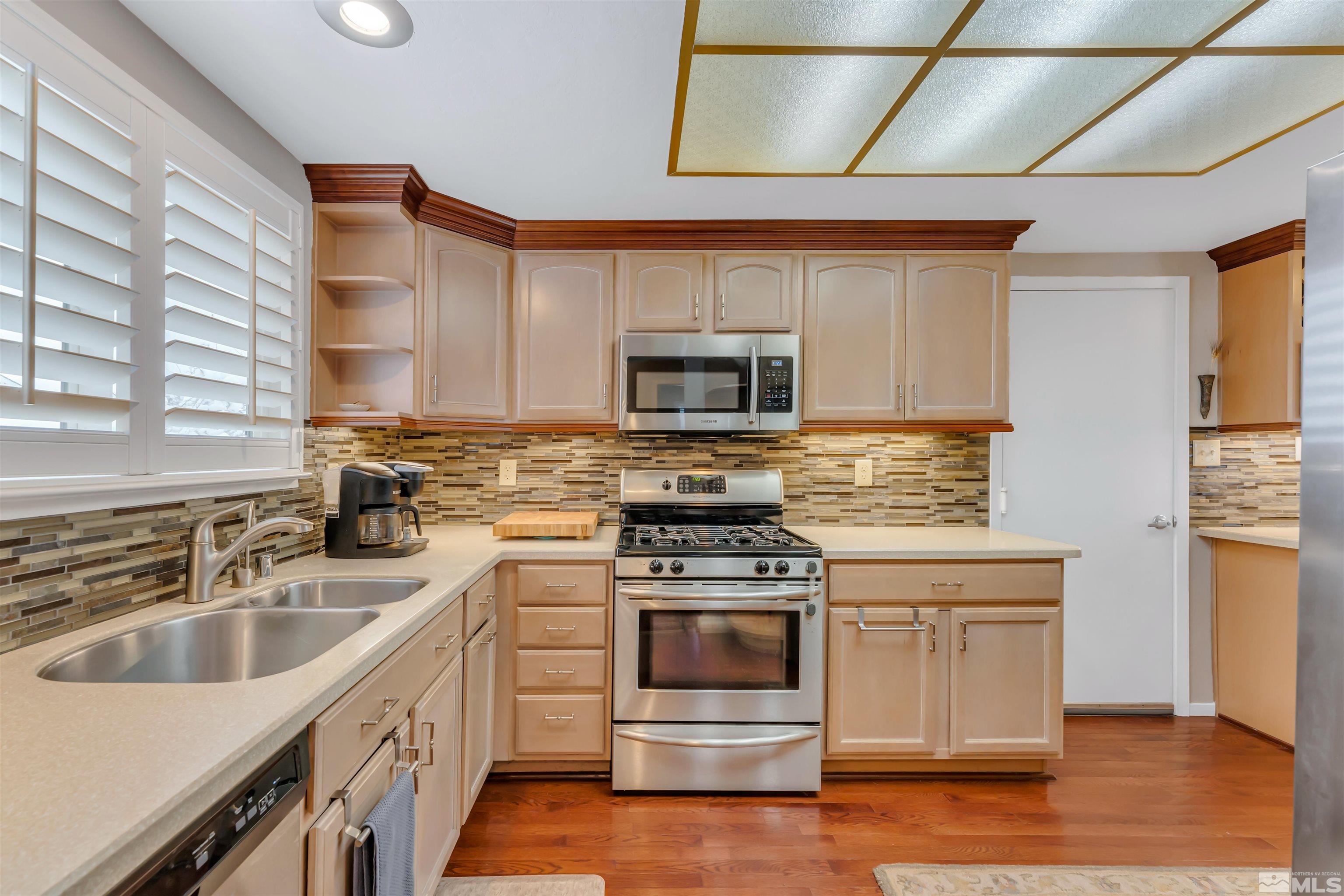 1243 Laredo Court Reno, NV 89503 - Photo 12 of 20 a kitchen with a sink stove top oven and cabinets