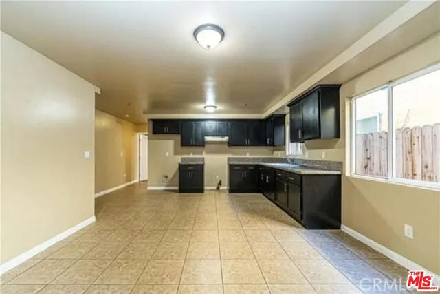 a large kitchen with a stove a sink dishwasher and a refrigerator