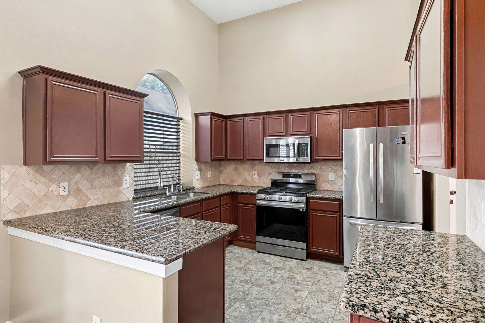 12411 Wright Oaks Drive Houston, TX 77014 - Photo 14 of 29 a kitchen with stainless steel appliances granite countertop a sink stove and refrigerator