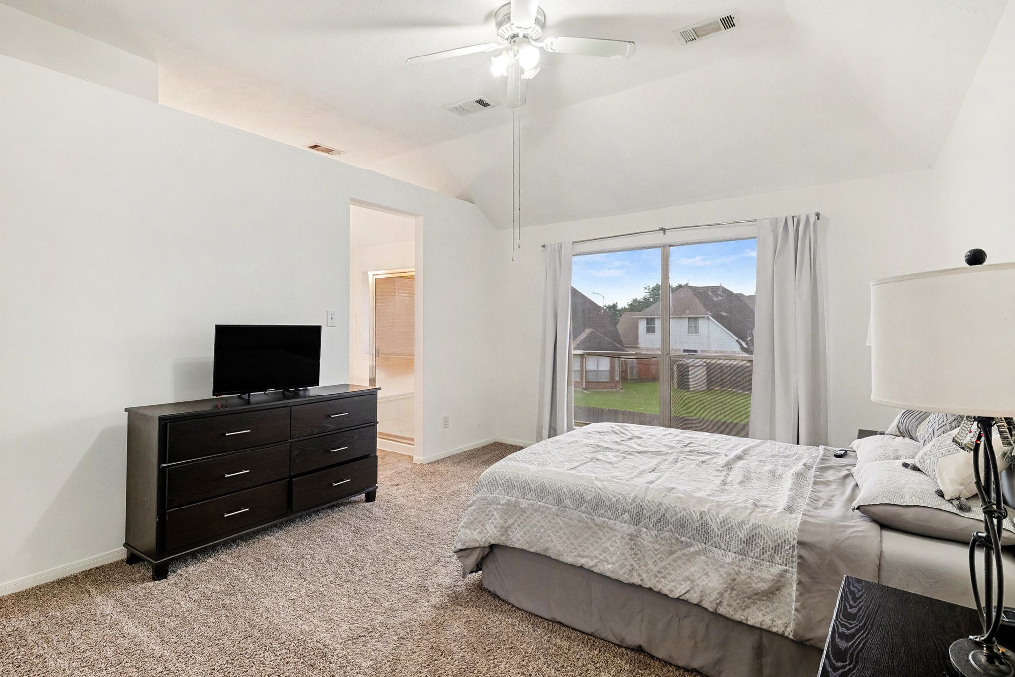 12411 Wright Oaks Drive Houston, TX 77014 - Photo 21 of 29 a bedroom with a bed and a large window