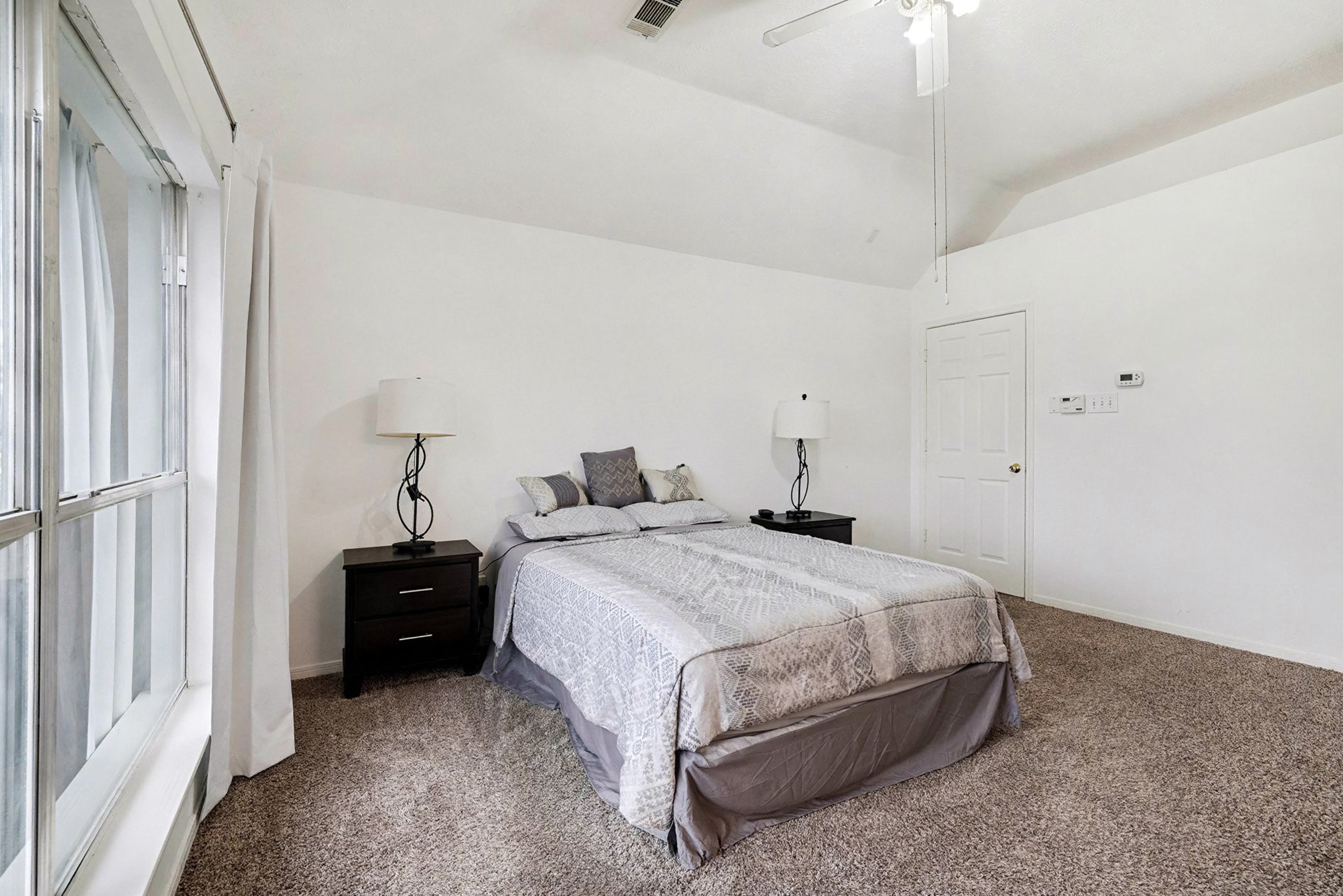 12411 Wright Oaks Drive Houston, TX 77014 - Photo 22 of 29 a spacious bedroom with a bed and a window