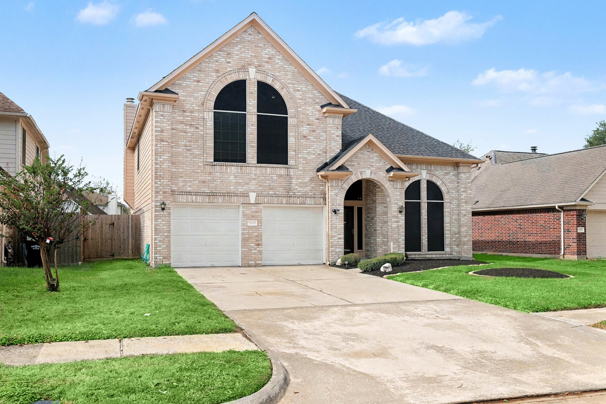 12411 Wright Oaks Drive Houston, TX 77014 - Photo 3 of 29 a front view of a house with a yard and garage