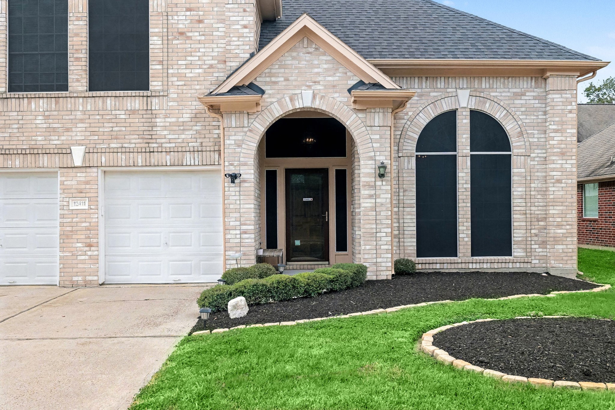 12411 Wright Oaks Drive Houston, TX 77014 - Photo 5 of 29 a front view of a house with garden