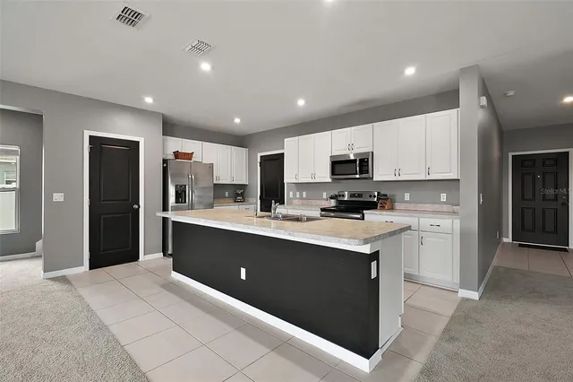 a kitchen with granite countertop a sink and cabinets