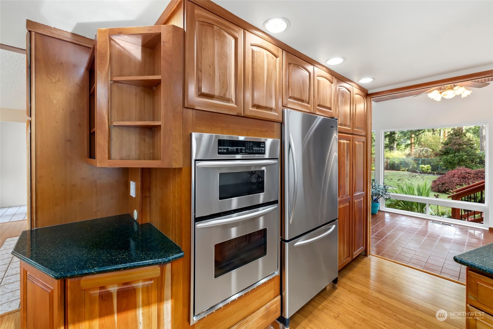 12730 Southeast 95th Place Renton, WA 98056 - Photo 11 of 38 a kitchen with stainless steel appliances granite countertop a refrigerator a stove and a sink