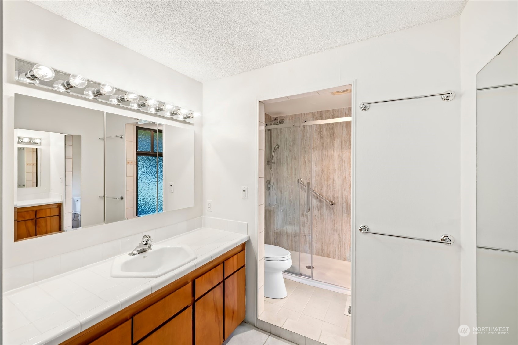 12730 Southeast 95th Place Renton, WA 98056 - Photo 21 of 38 a bathroom with a granite countertop sink a toilet and shower