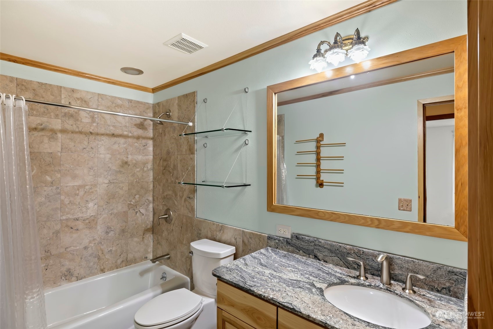 12730 Southeast 95th Place Renton, WA 98056 - Photo 25 of 38 a bathroom with a granite countertop sink toilet a mirror a bathtub and shower