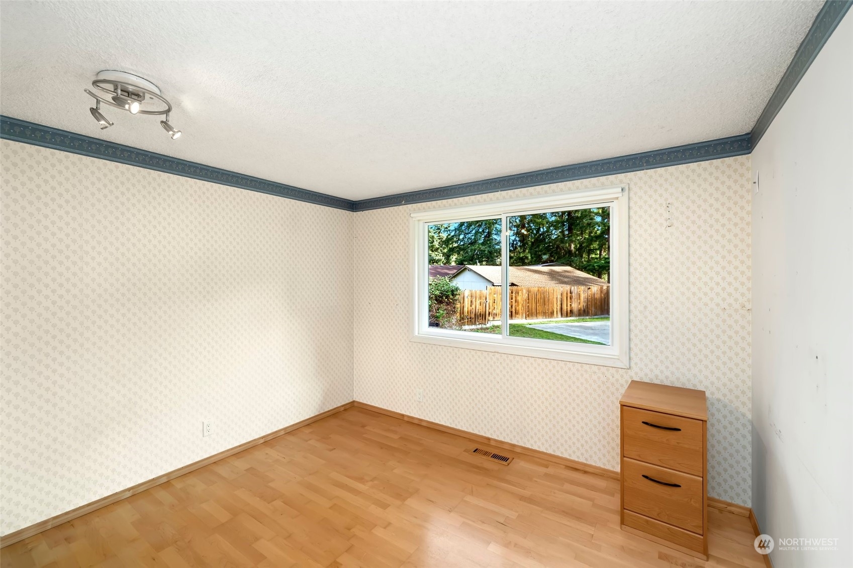 12730 Southeast 95th Place Renton, WA 98056 - Photo 28 of 38 a view of an empty room with wooden floor and a window
