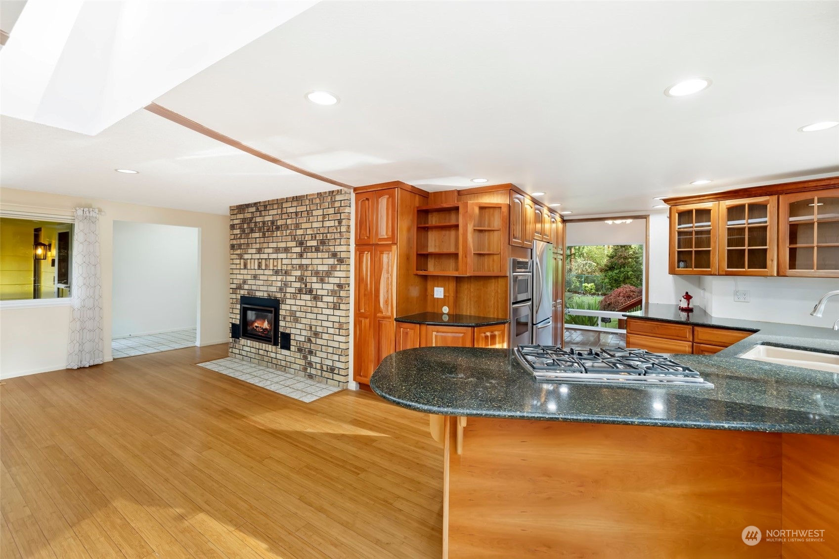 12730 Southeast 95th Place Renton, WA 98056 - Photo 6 of 38 a kitchen with stainless steel appliances granite countertop a granite counter tops and a view of living room